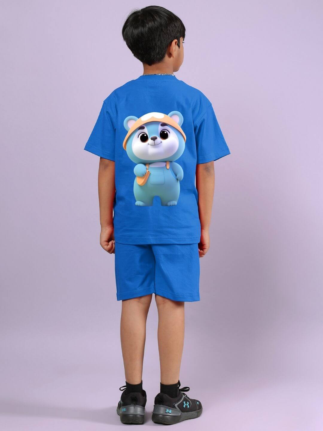Child wearing SMILEY BEAR CO-ORD FOR BOYS AND GIRLS BLUE with cartoon bear design.