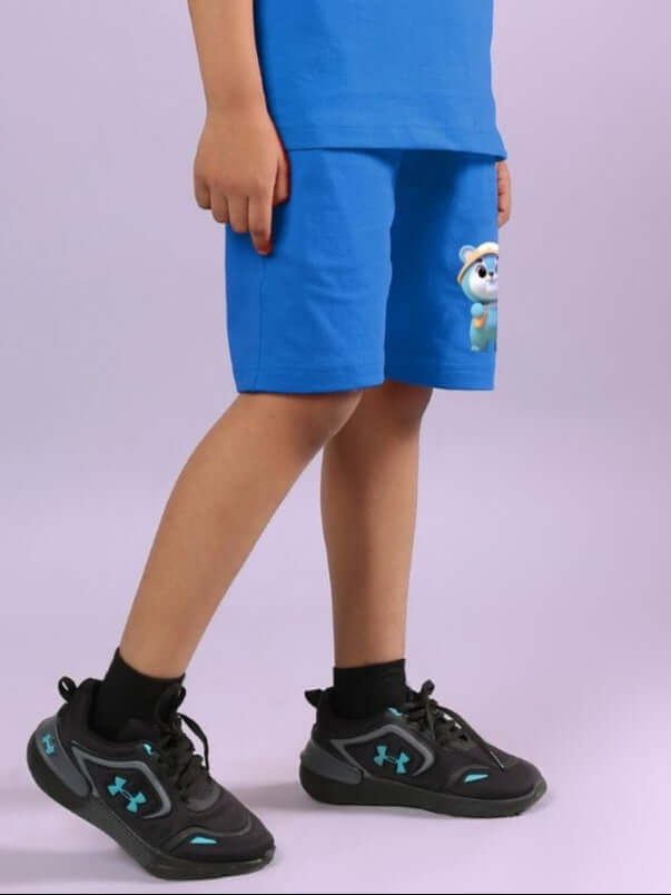 Child wearing SMILEY BEAR SHORTS FOR BOYS AND GIRLS BLUE, featuring a cute bear design, perfect for playful and comfortable kids' fashion.