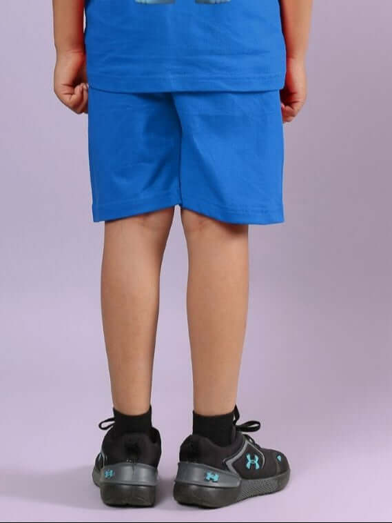Child wearing blue Smiley Bear shorts with elastic waistband, showcasing casual style and comfort for boys and girls.