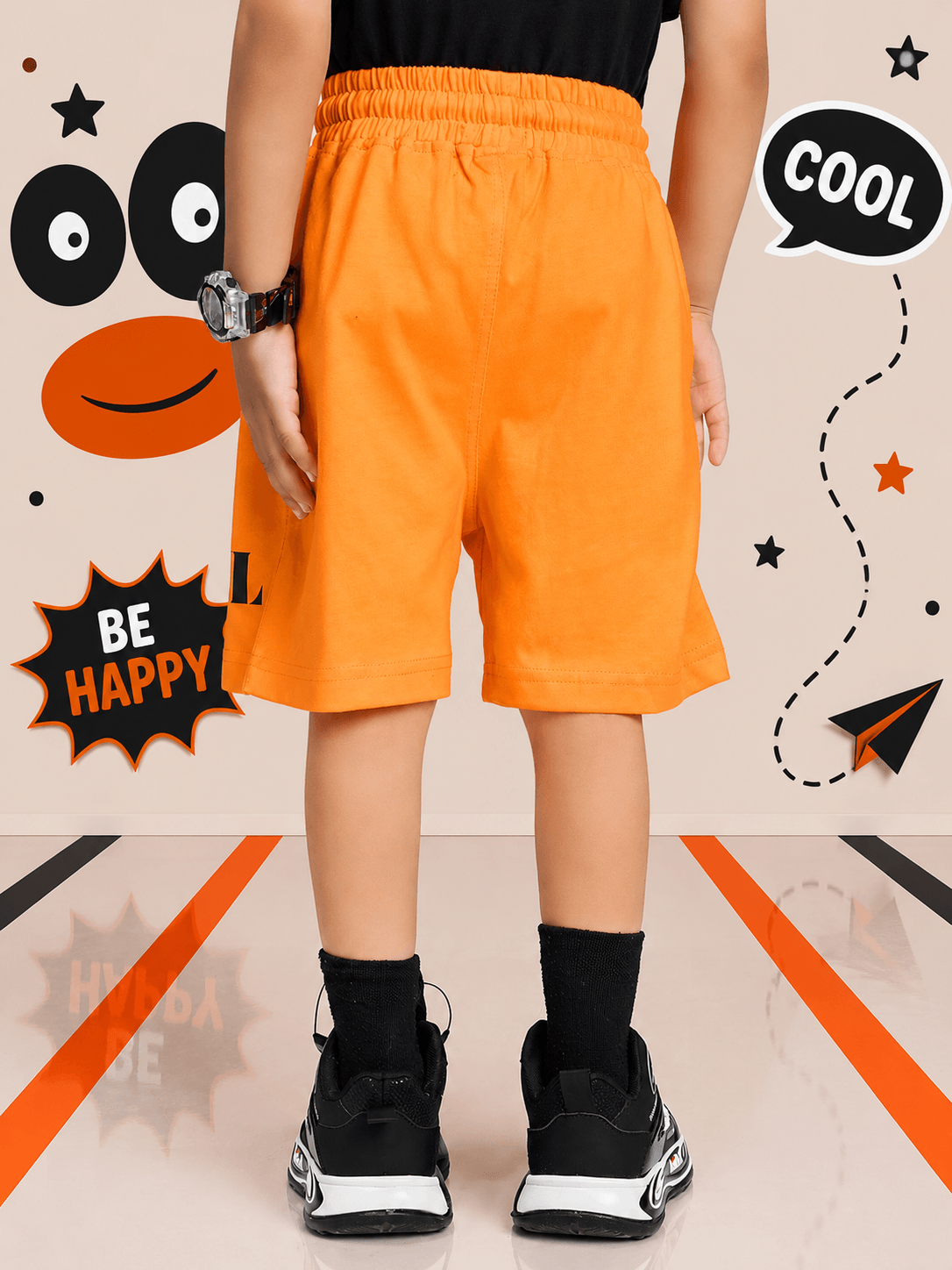 SMILEY EYES COOL SHORTS FOR BOYS GIRLS ORANGE back view on a child in a playful setting with fun graphics