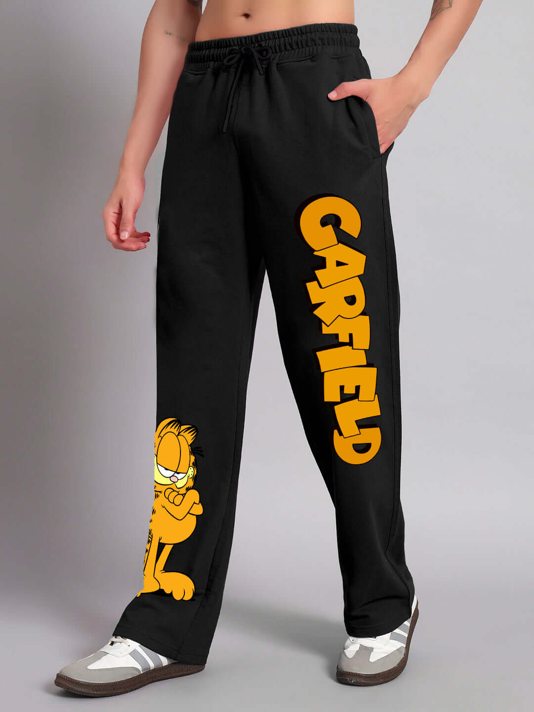 Black relaxed fit joggers featuring a smug Garfield print with "Garfield" text in yellow, designed by DUDS, customizable size option available.