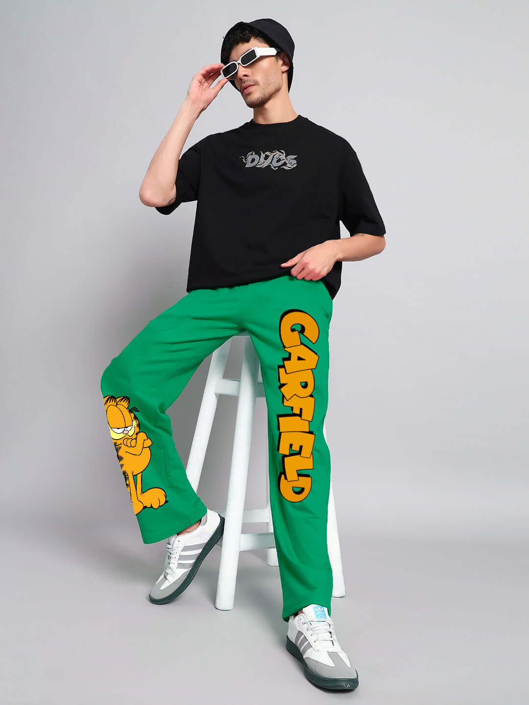 Model wearing SMUG GARFIELD Relaxed Fit Jogger in green with Garfield print, styled with DUDS t-shirt, perfect for casual wear.