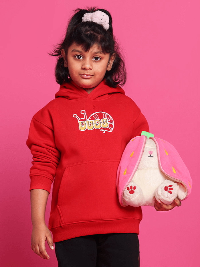 Child wearing SNAIL OVERSIZED HOODIE BOYS & GIRLS RED holding a plush toy, showcasing the vibrant color and comfortable fit.