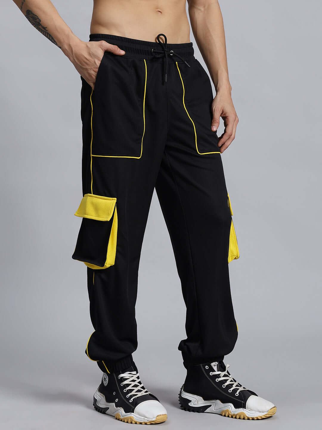 SOCCER REGULAR FIT CARGO JOGGER BLACK pants with yellow accents, displayed on a model, ideal for customized size options and made-to-order craftsmanship.