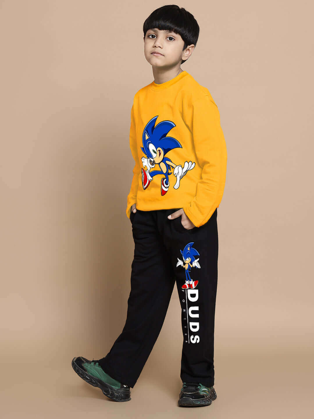 Child wearing yellow and black Sonic co-ord set for boys and girls by DUDS, featuring Sonic graphic on sweatshirt and pants.