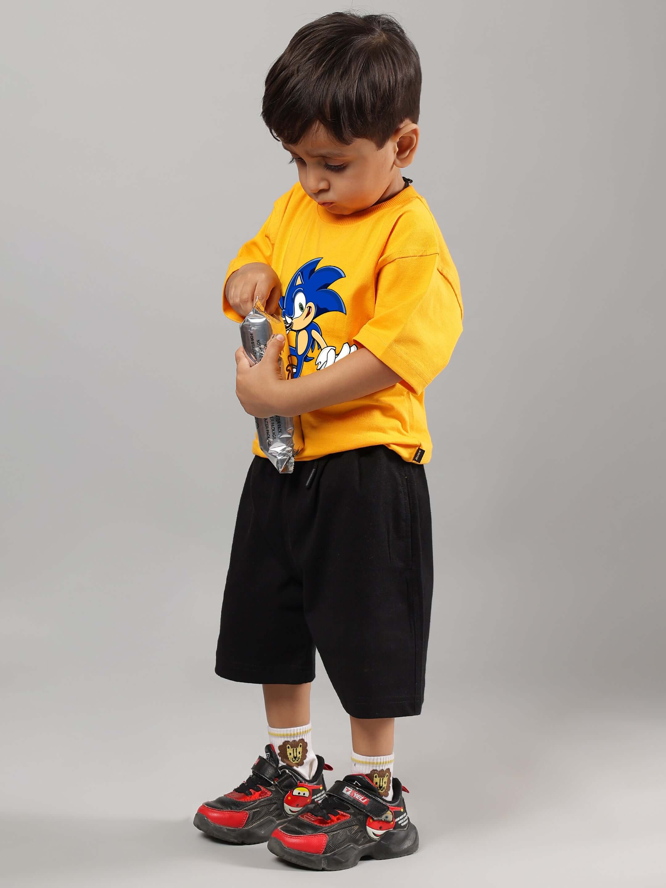 SONIC SUMMER CO-ORD FOR BOYS GIRLS YELLOW-BLACK, featuring a child wearing vibrant yellow and black Sonic-themed outfit with shorts.