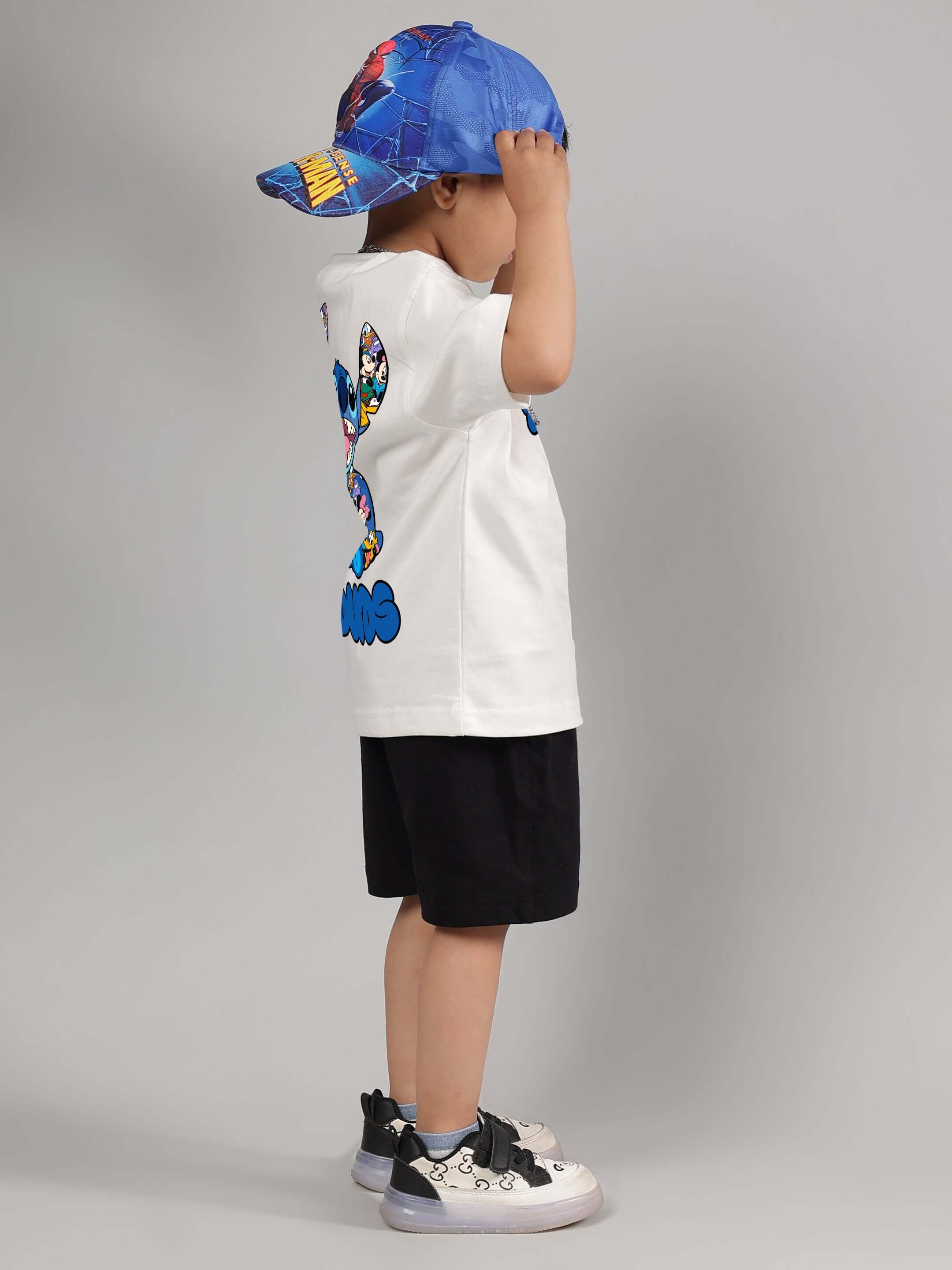 Child wearing SORE SUMMER CO-ORD FOR BOYS GIRLS OFF WHITE-BLACK, featuring a graphic t-shirt and black shorts.