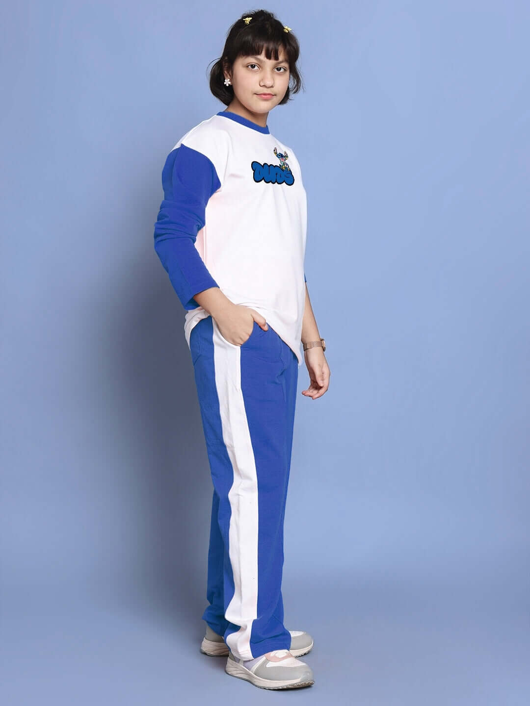 Child wearing SORE oversized co-ord set in white-blue with red-white jogger panels, unisex relaxed fit, elastic waistband. Premium cotton.