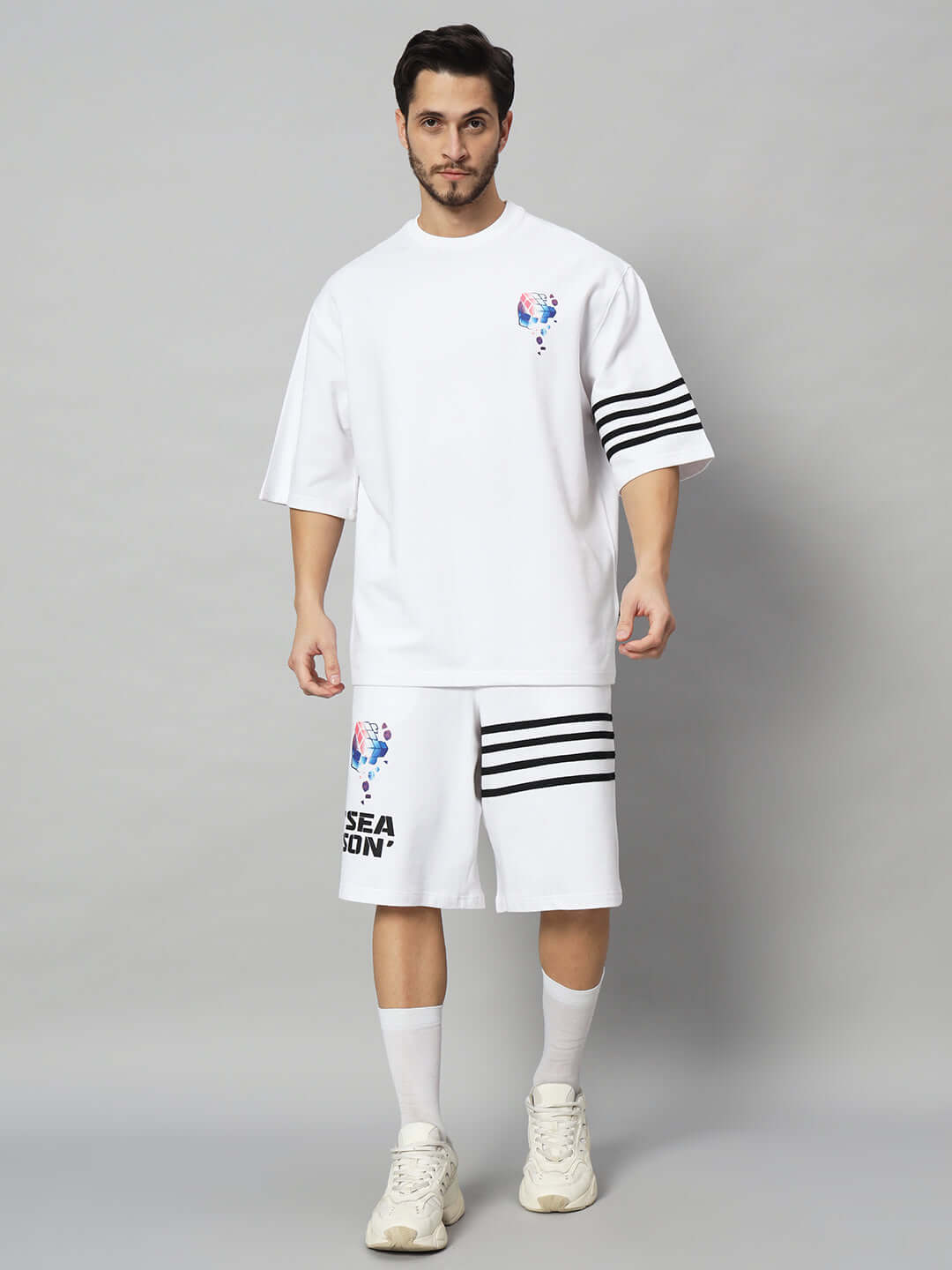 Model wearing SOUND SEASON white co-ord set made from premium cotton, featuring a stylish design with bold stripes and logo.