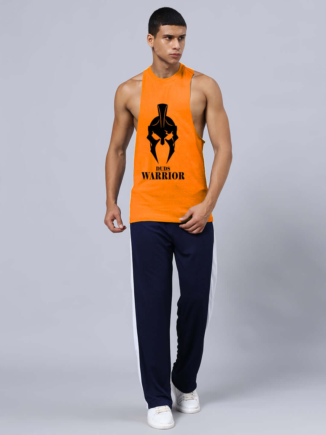 Man wearing orange Spartan Warrior printed gym t-shirt with custom fit option, promoting DUDS apparel.