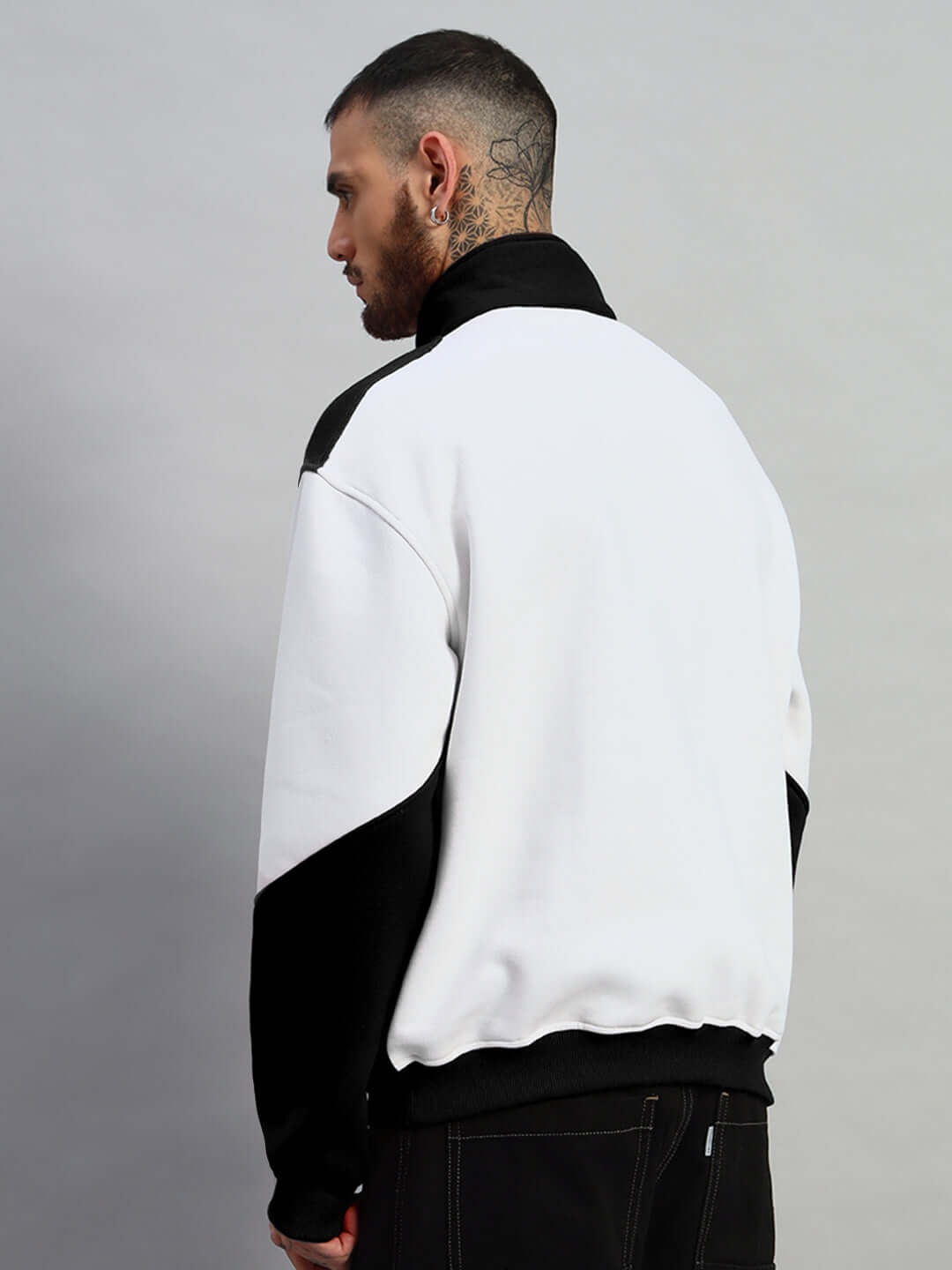 Model wearing SPEEDING Colorblock Jacket in black, side view, highlighting tailored fit. Customizable options available from DUDS.