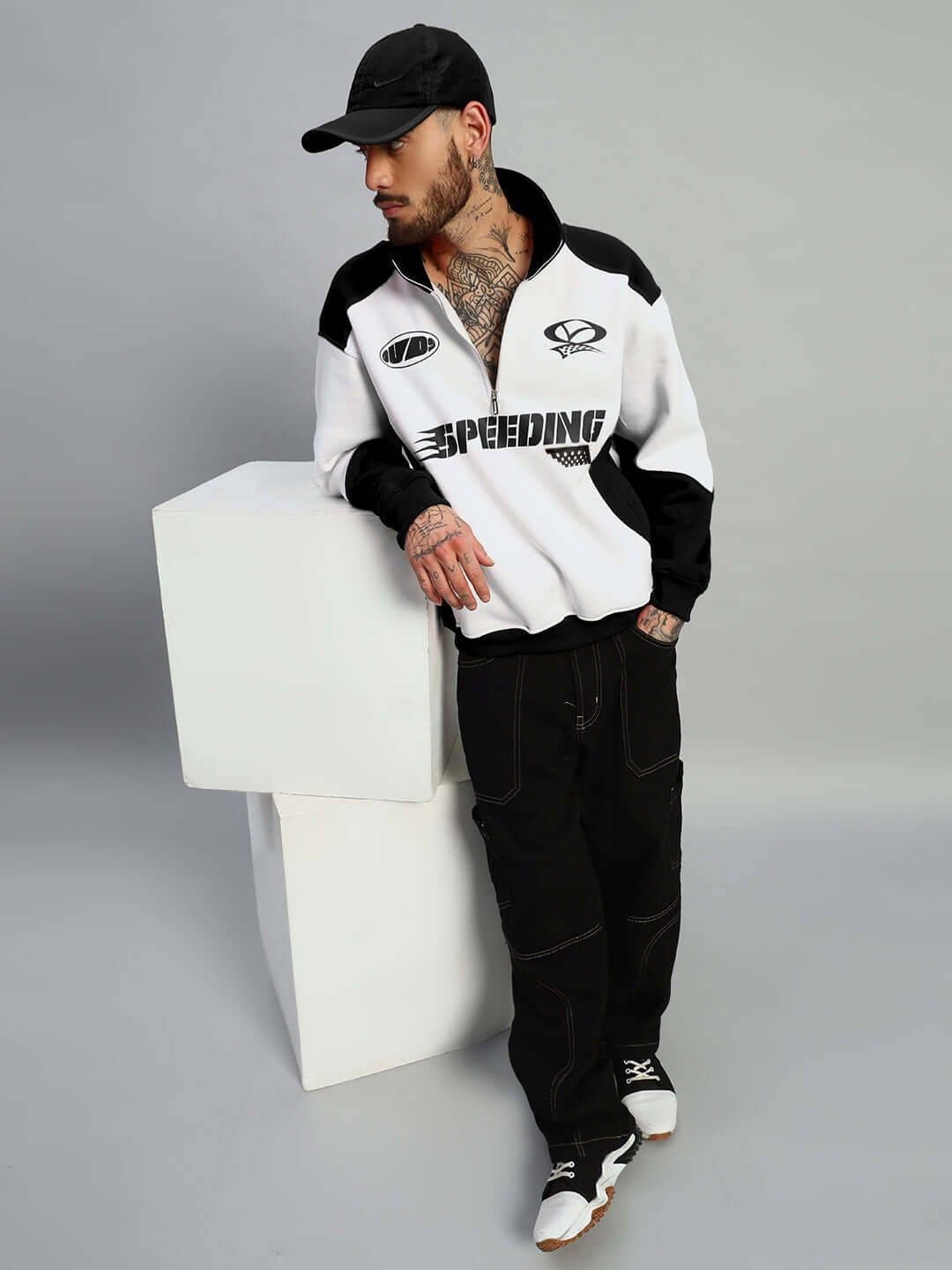 Model wearing SPEEDING colorblock jacket in black and white by DUDS, showcasing trendy fashion style with custom fit option.