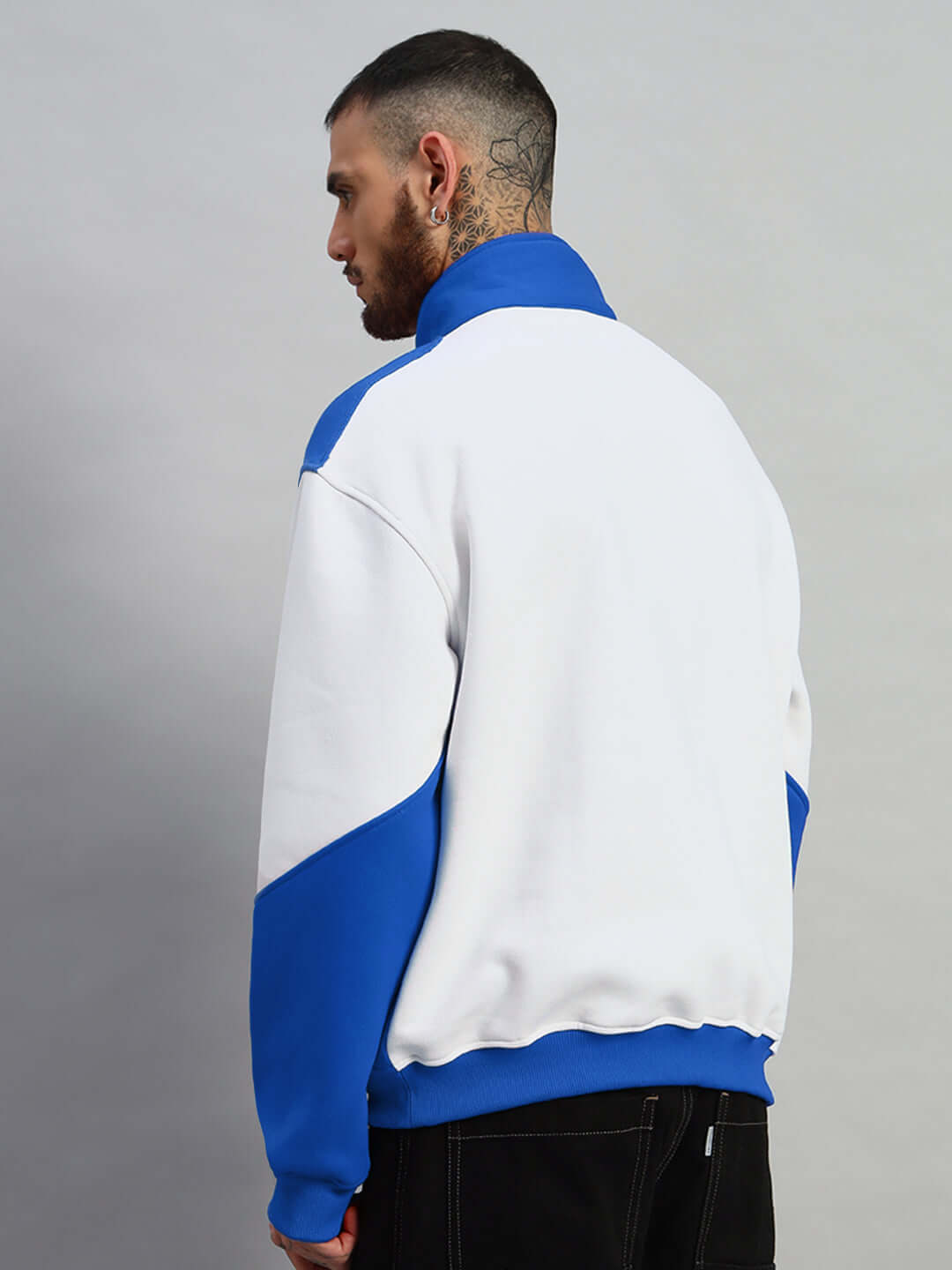 Back view of model wearing SPEEDING Colorblock Jacket in royal blue and white by DUDS, showcasing unique design and fit.