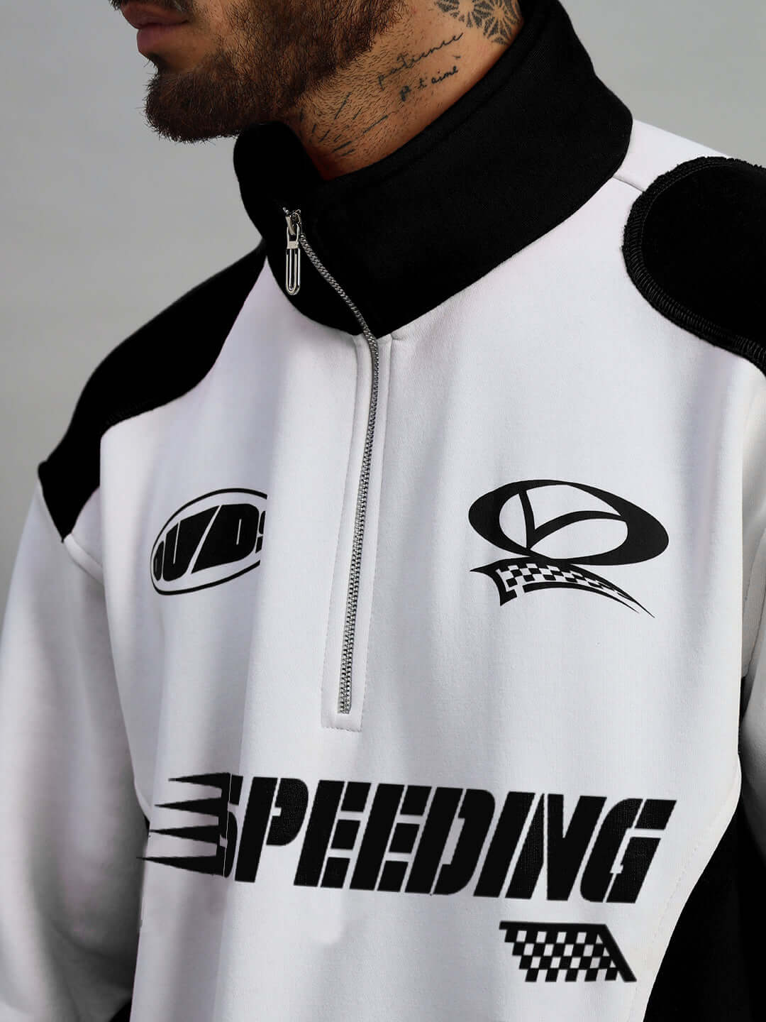 Model wearing black Speeding Colorblock Jacket with zipper, designed by DUDS, featuring bold racing graphics.