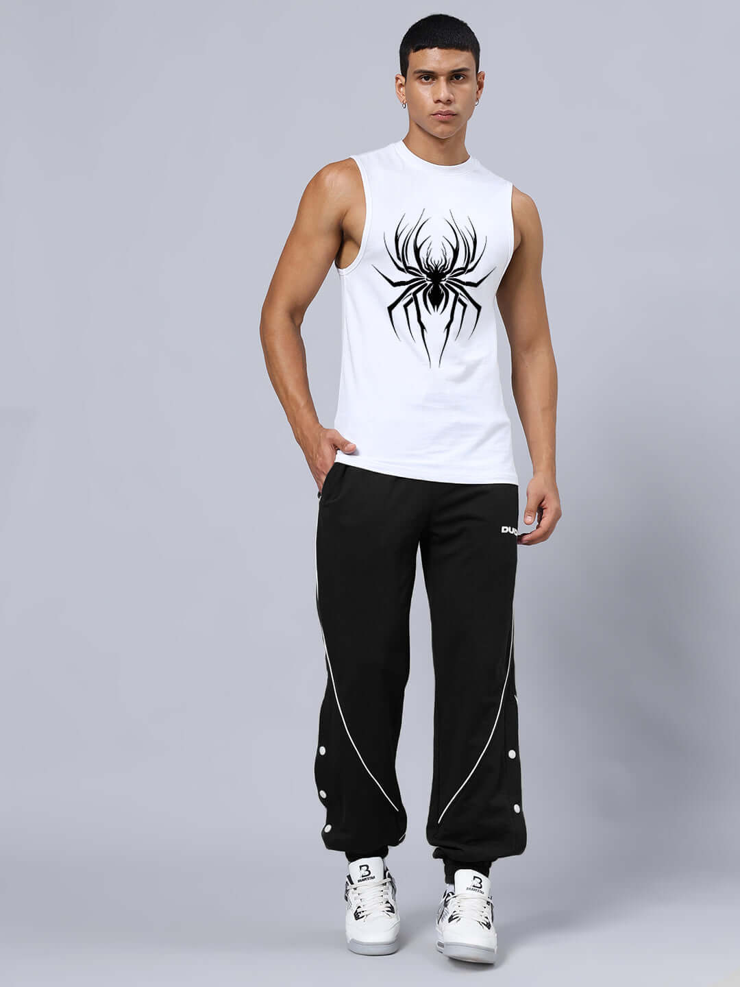 Model wearing SPIDER PRINTED GYM RELAXED FIT CO-ORD SET WHITE-BLACK with spider print, comfortable joggers, and cotton material.