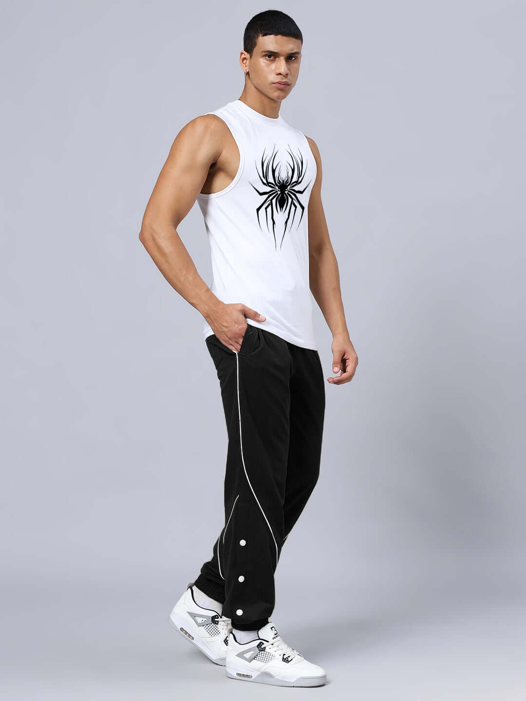 Model wearing SPIDER PRINTED GYM RELAXED FIT CO-ORD SET WHITE-BLACK, featuring a spider print top and black joggers with white sneakers.