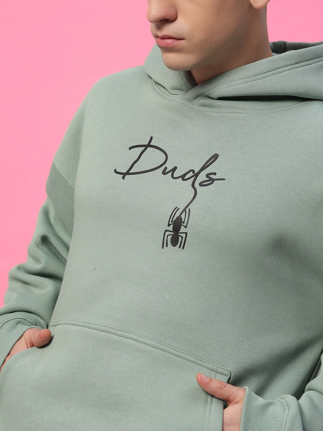 Model wearing Spiderman Oversized Fleece Hoodie Jade Green with spider graphic, showcasing trendy and relaxed fit streetwear.