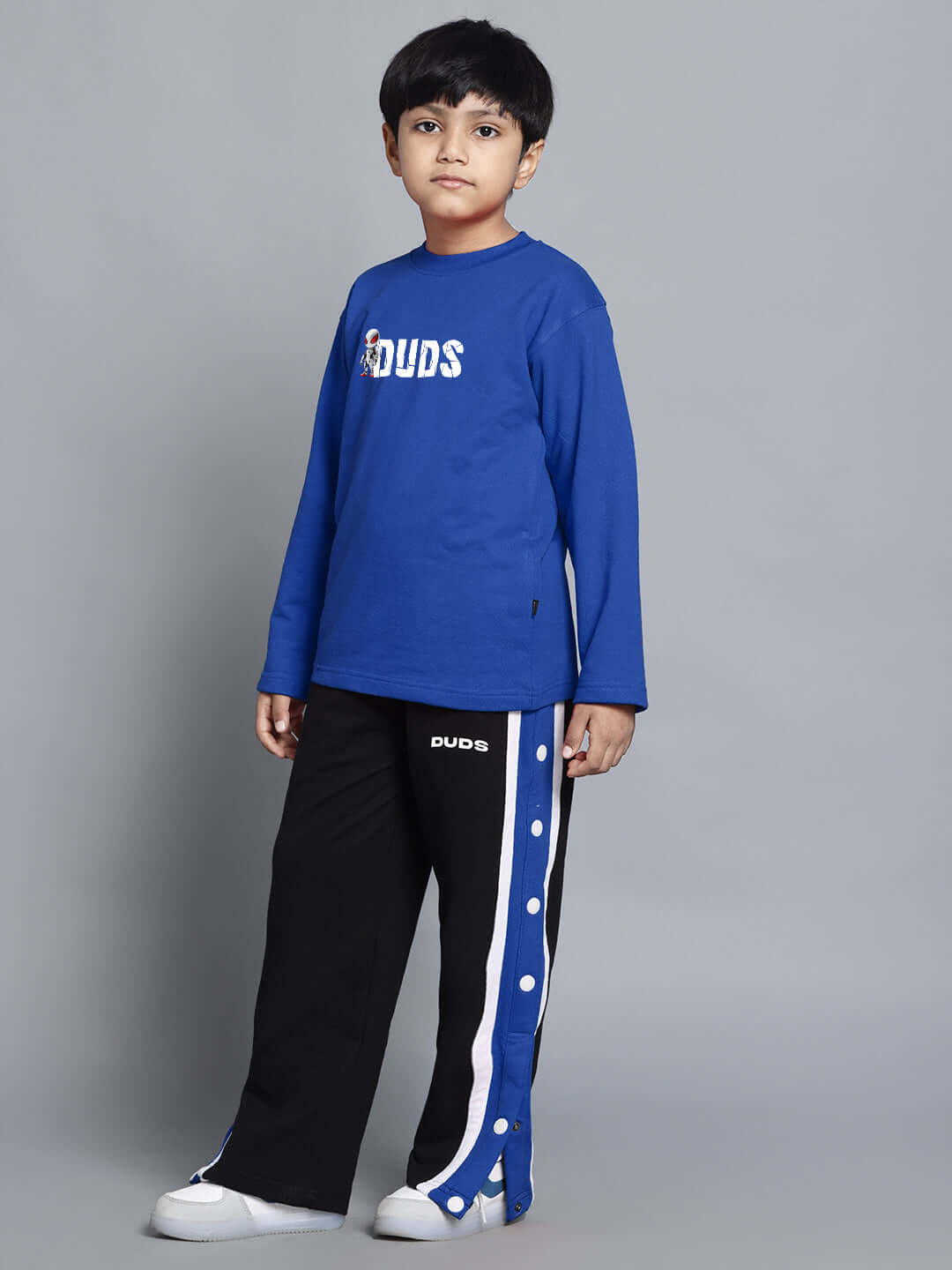 Boy wearing SPIDERROBO COTTON CO-ORD FOR BOYS AND GIRLS BLUE BLACK, featuring blue top and black pants with stylish design.