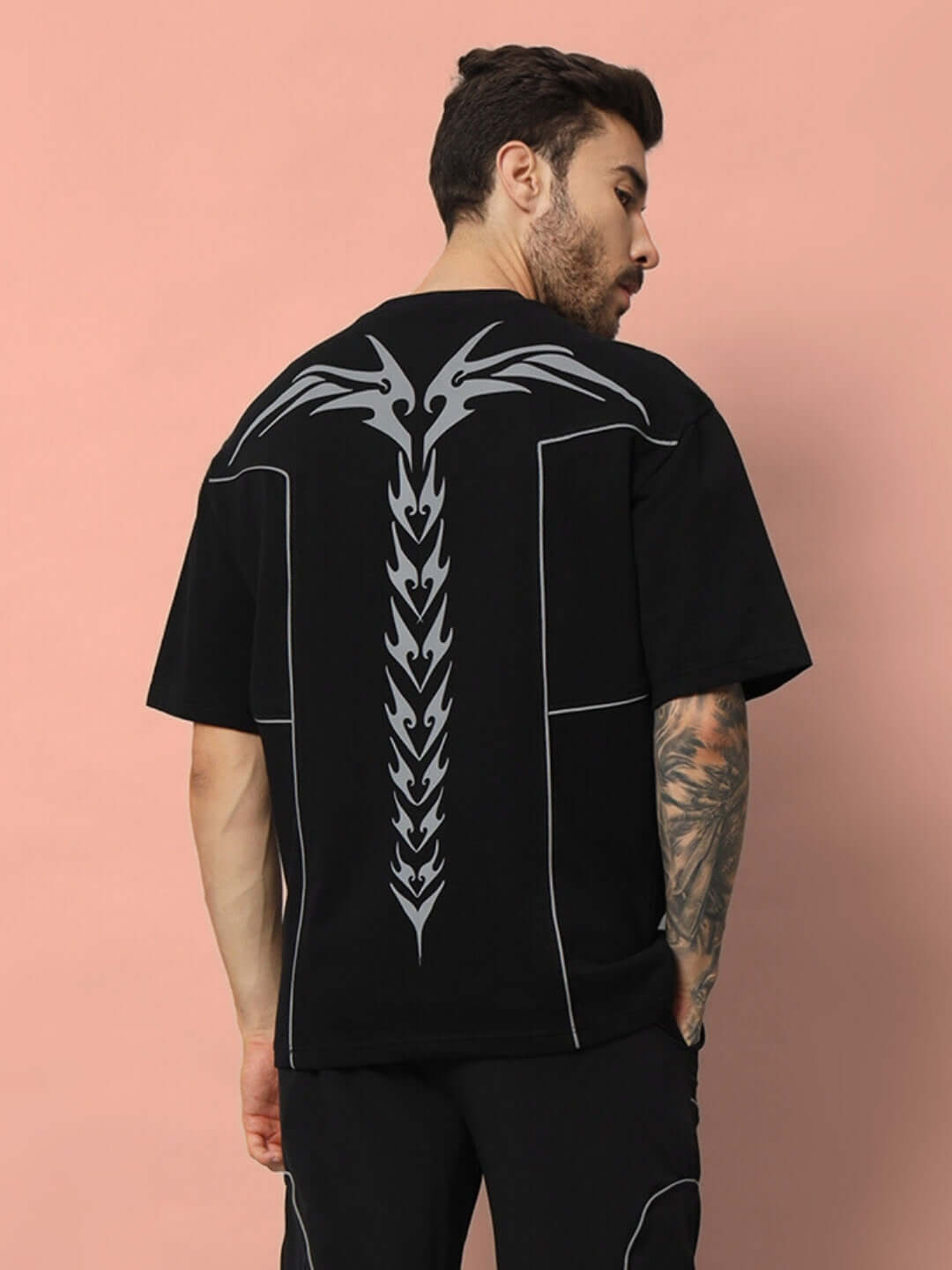 Model wearing Spinal Faux Reflector Over-Sized Black T-Shirt, featuring premium cotton fabric and bold back design.