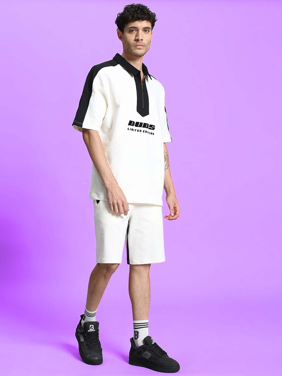 Man wearing Splinter Regular Fit Shorts Off White, styled with casual top and sneakers, showcasing casual and trendy outfit.