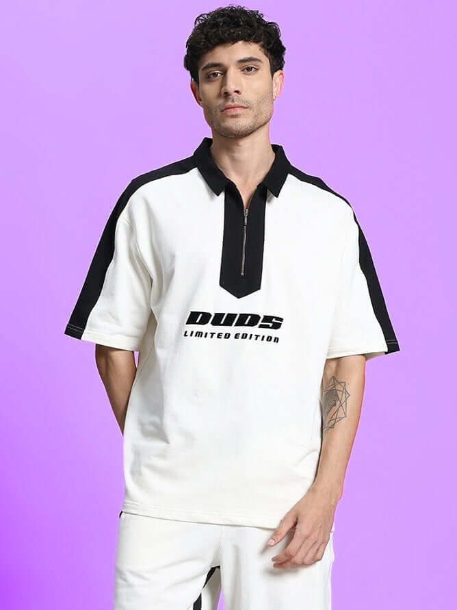 Man wearing SPLINTER OVER-SIZED T-SHIRT OFF WHITE with black details, urban streetwear style.