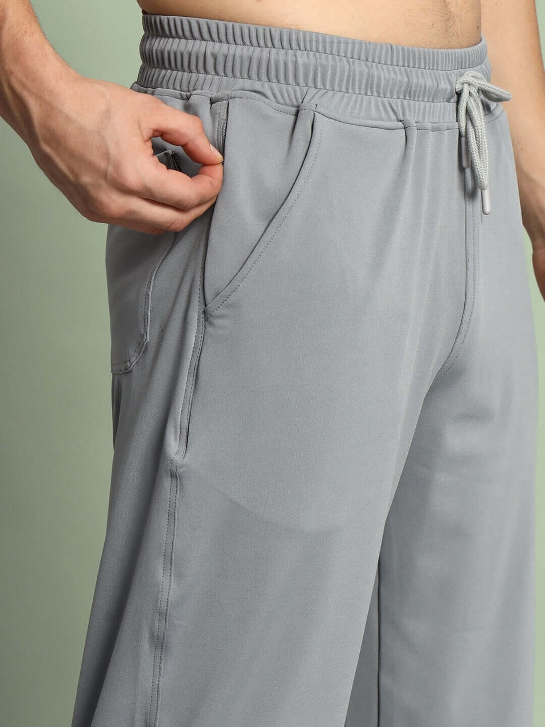 Grey relaxed fit joggers with elastic waistband, drawstring, and side pockets, designed for comfort and style; perfect for custom fitting.