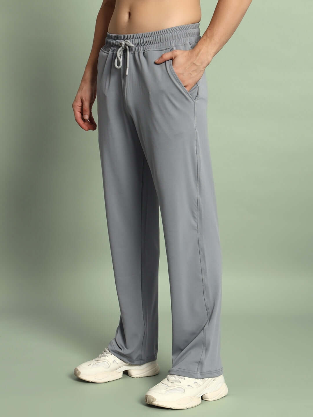Model wearing grey Springy Relaxed Fit Joggers with drawstring waistband, showcasing comfortable and stylish made-to-order apparel by DUDS.