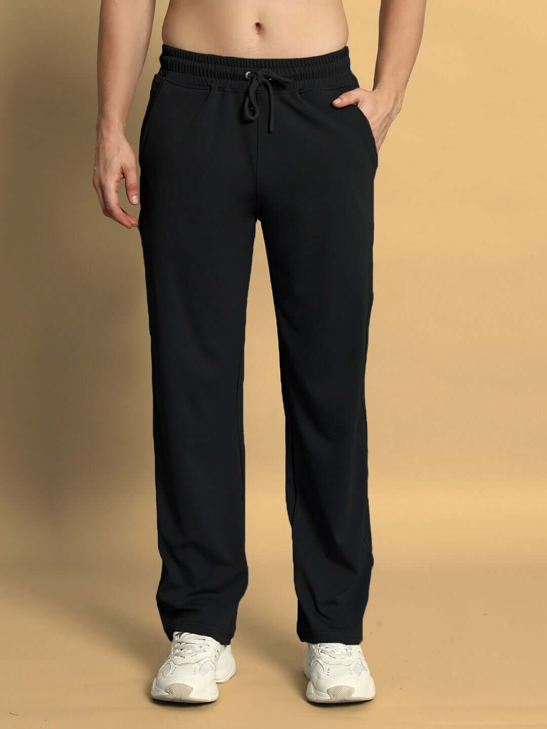 Black springy relaxed fit jogger pants displayed on a model with hands in pockets, tailored by DUDS, offering comfort and style.