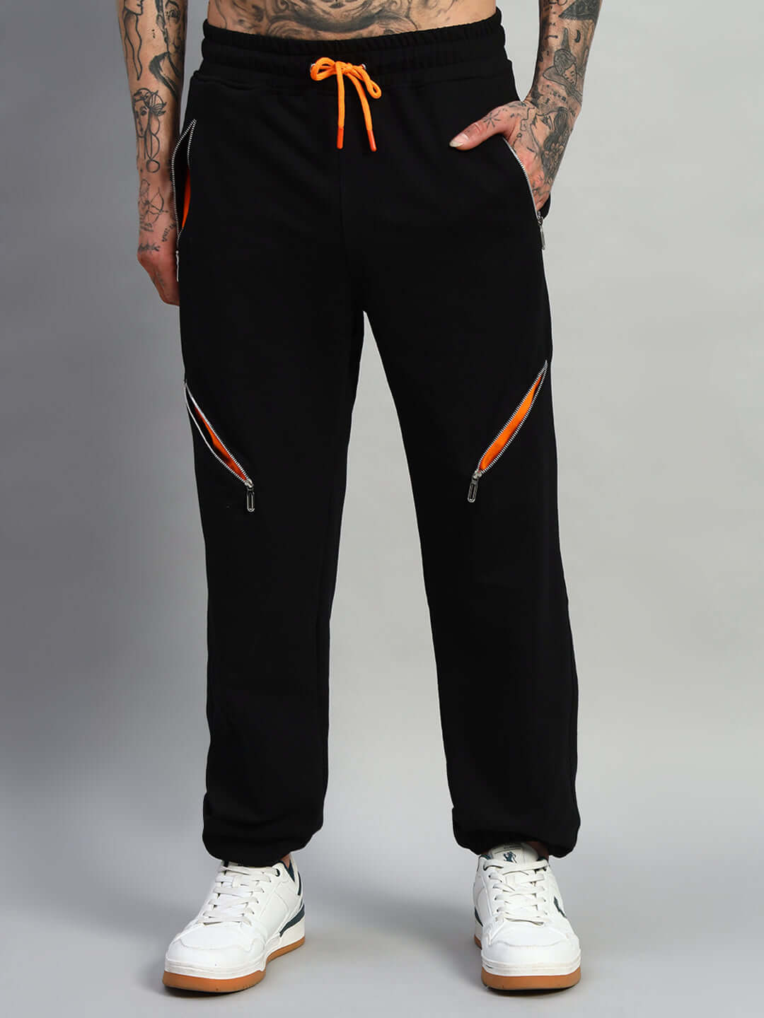 Stylish black Squall joggers with orange drawstring and zippers, showcasing customized fit and comfort by DUDS Tailors.