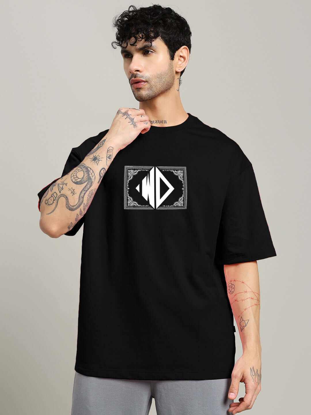 Model wearing black square frame oversized T-shirt with graphic design, made from premium heavy gauge cotton fabric.
