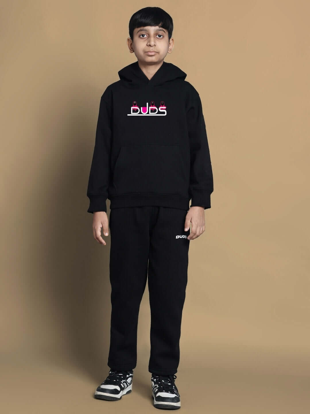 Child wearing a black DUDS oversized hoodie, perfect for boys and girls, custom fit available, made to order with a 7-10 day dispatch.