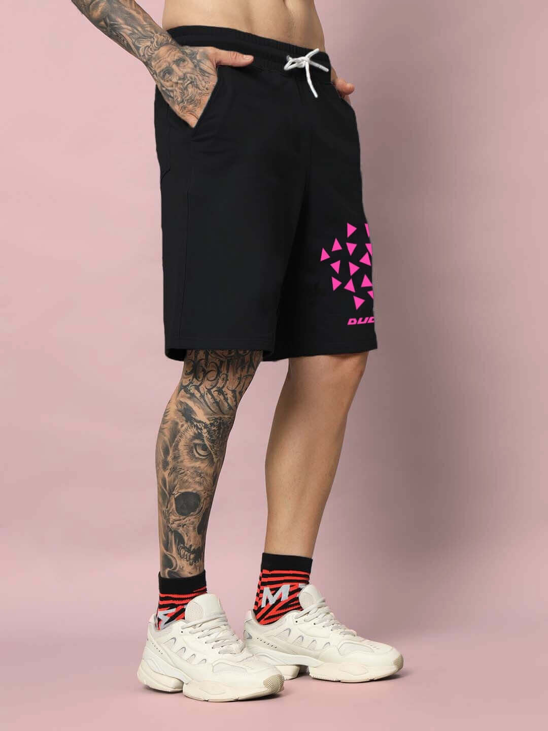 Person wearing Star Dust Regular Fit Black Shorts with pink geometric pattern, showcasing casual style and comfort.