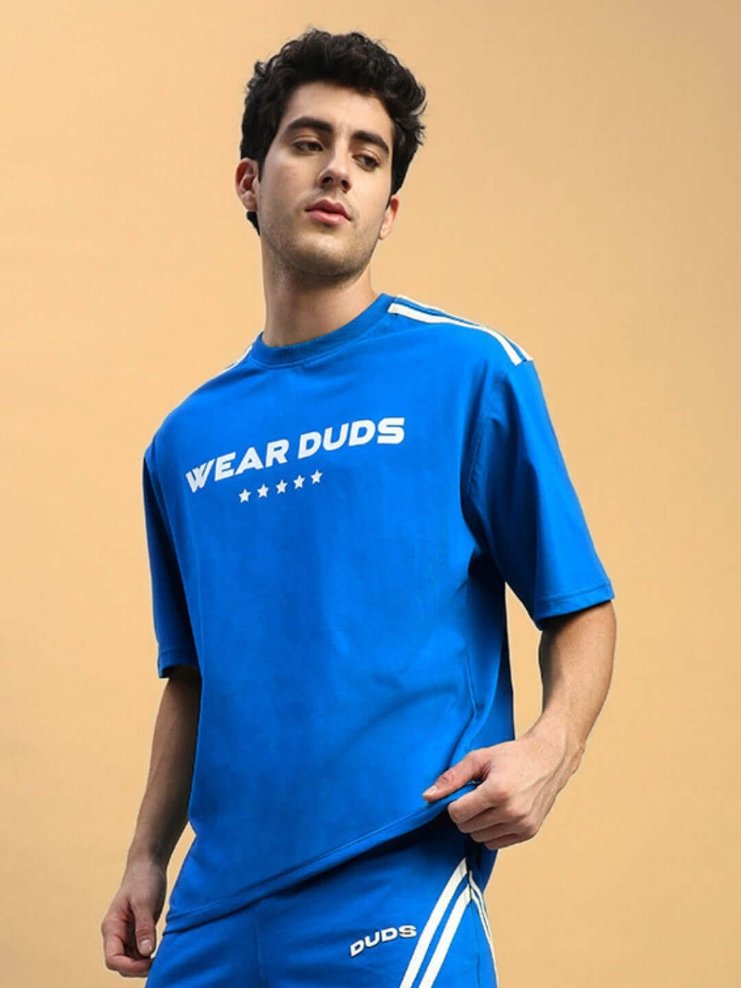 Model wearing STAR JUMPER OVER-SIZED T-SHIRT ROYAL BLUE in a casual streetwear style.