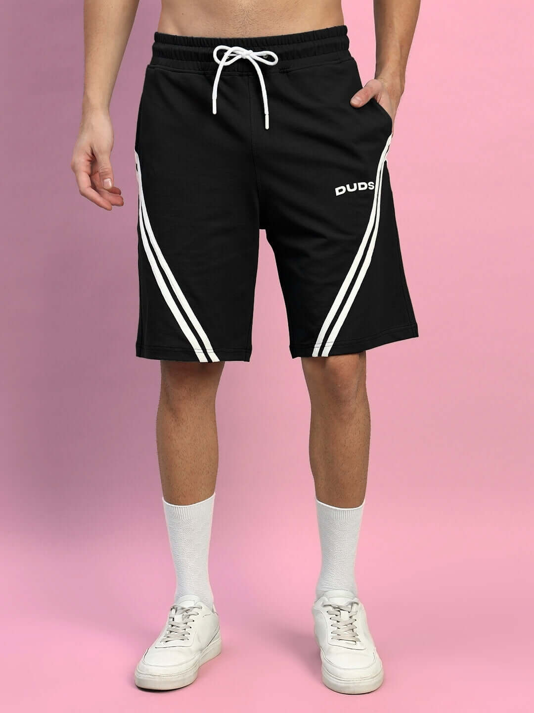 Man wearing STAR JUMPER Regular Fit Black Shorts by DUDS with white stripes, customizable size option available.