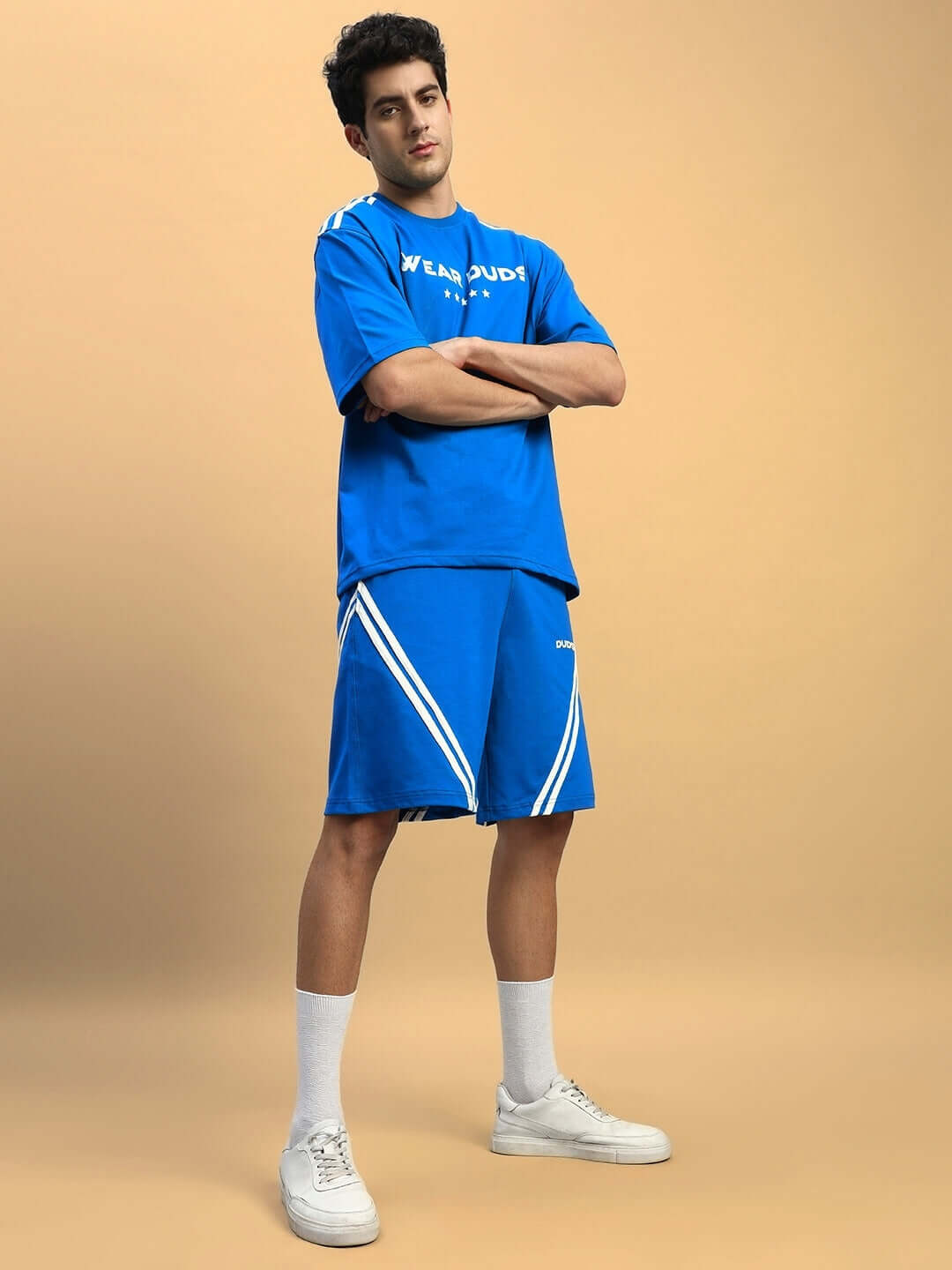 Model wearing STAR JUMPER SUMMER CO-ORD SET ROYAL BLUE, featuring oversized t-shirt and matching shorts for a stylish casual look.