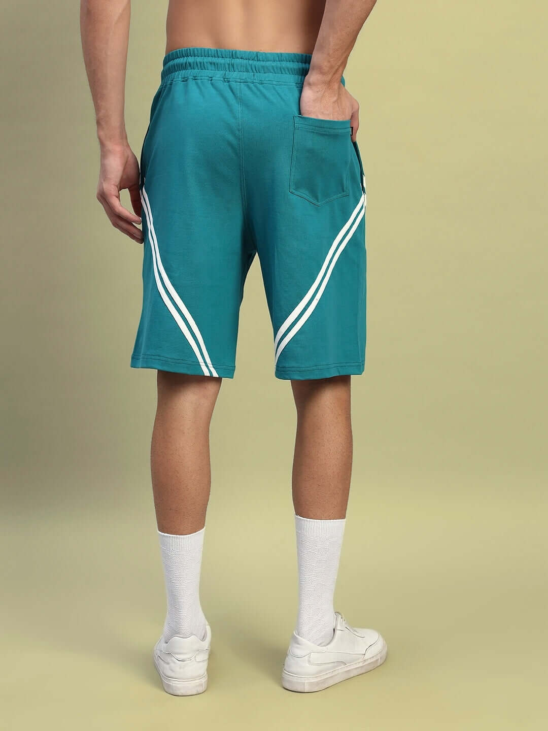 Back view of model wearing teal STAR JUMPER SUMMER CO-ORD shorts, featuring white stripe detail, made from premium cotton French terry lycra.