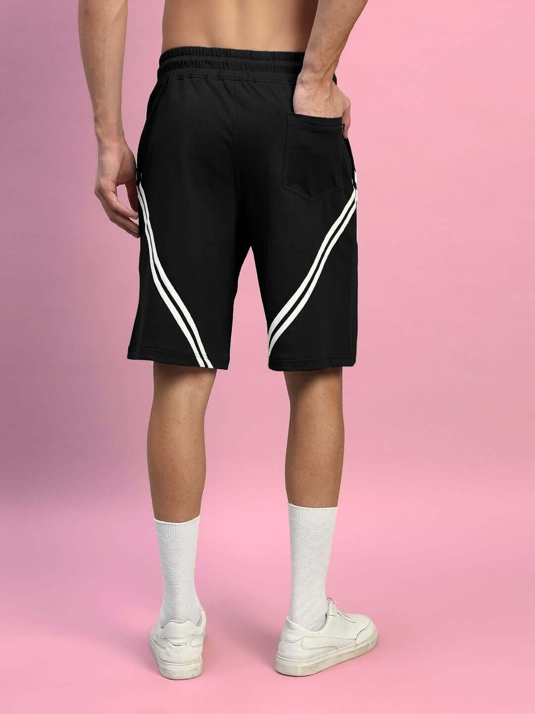 Back view of model wearing STAR JUMPER regular fit black shorts, featuring stylish stripes, perfect for versatile and comfortable wear.