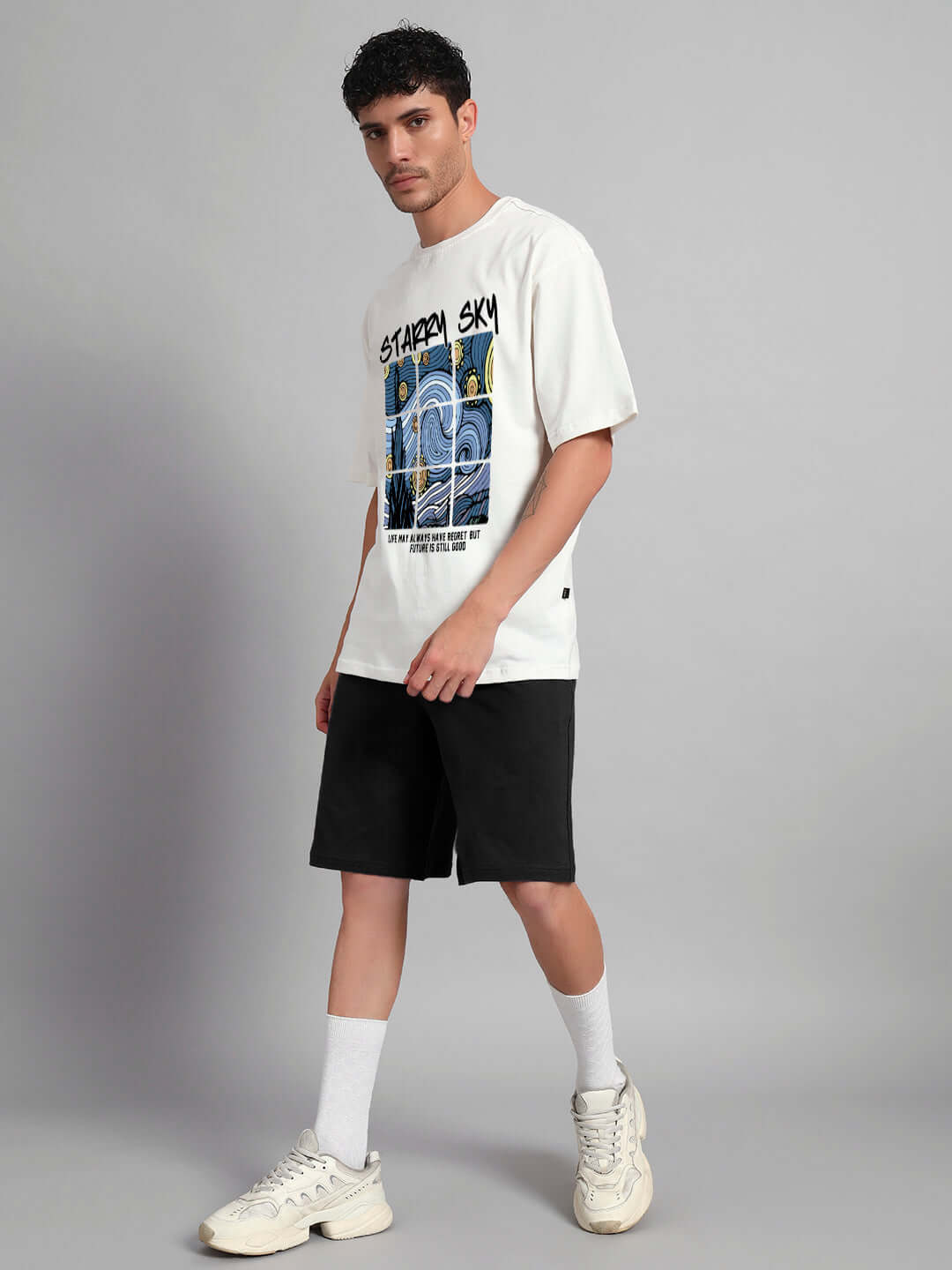 Model wearing Starry Sky Co-Ord Set with off white t-shirt and black shorts, made of premium cotton and elastane, stylish casual wear.