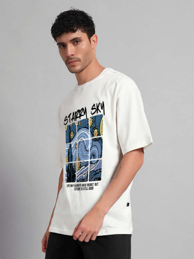 Man wearing Starry Sky Oversized T-Shirt in off white, featuring celestial graphic and relaxed fit, made from 100% cotton.