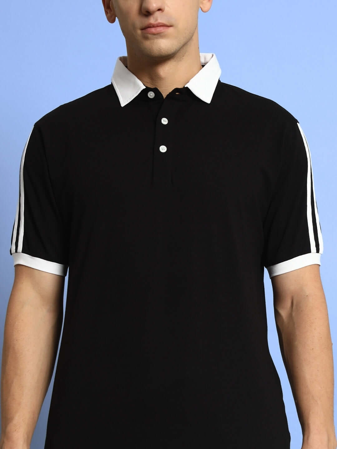 Model wearing Staunch Polo Regular Fit T-Shirt in black with white trim, half sleeves, 100% cotton; perfect for all-day comfort.