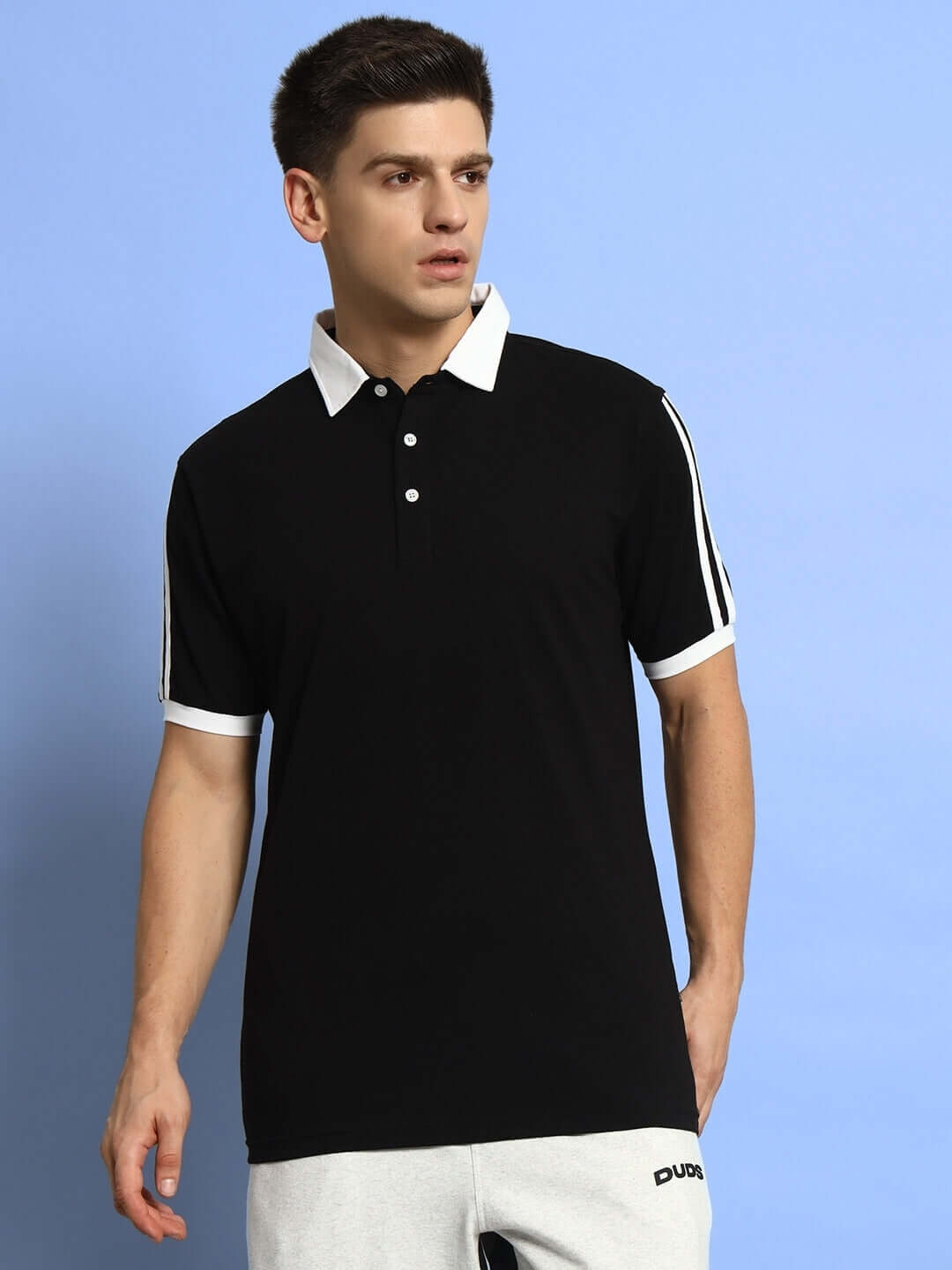 Model wearing Staunch Polo Regular Fit T-Shirt in black, half sleeves, 100% cotton, perfect for all-day wear.