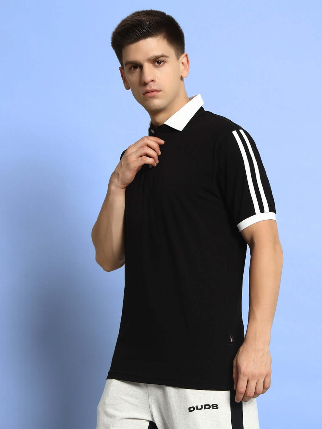 Model wearing STAUNCH black polo regular fit t-shirt with half sleeves, 100% cotton, suitable for all day wear. Country of Origin: India.