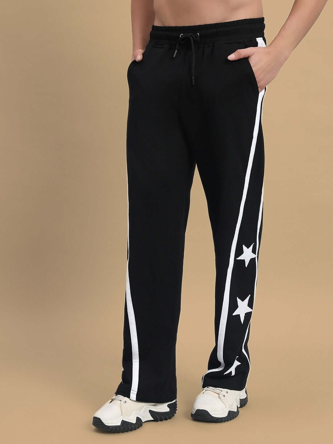Black joggers with white star design on sides, showcasing relaxed fit and premium tailoring by DUDS. Custom fit option available.