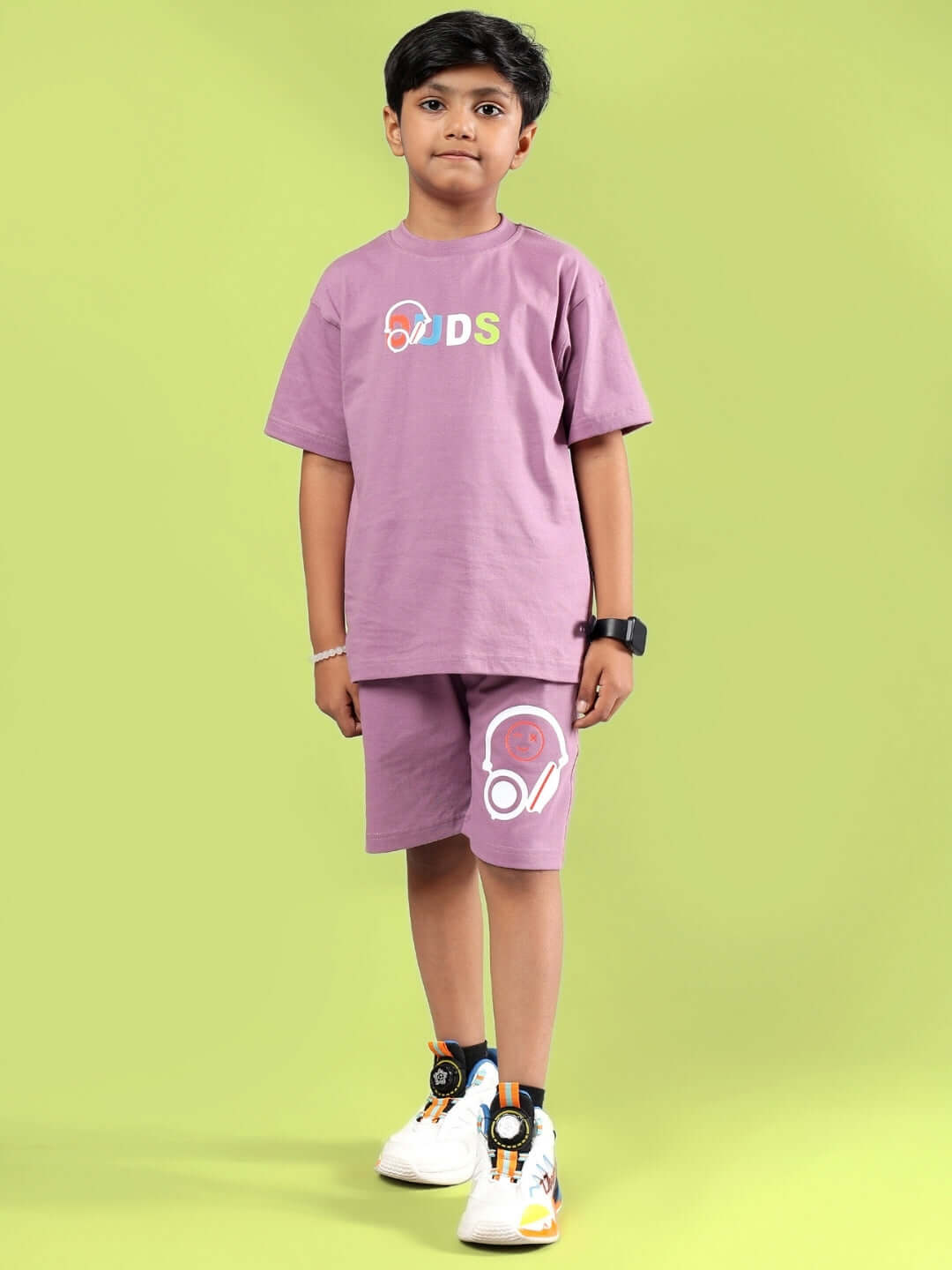 Boy wearing STOIC Co-Ord set in Pulm Purple from DUDS, showcasing comfortable and stylish kidswear, available for custom fit.
