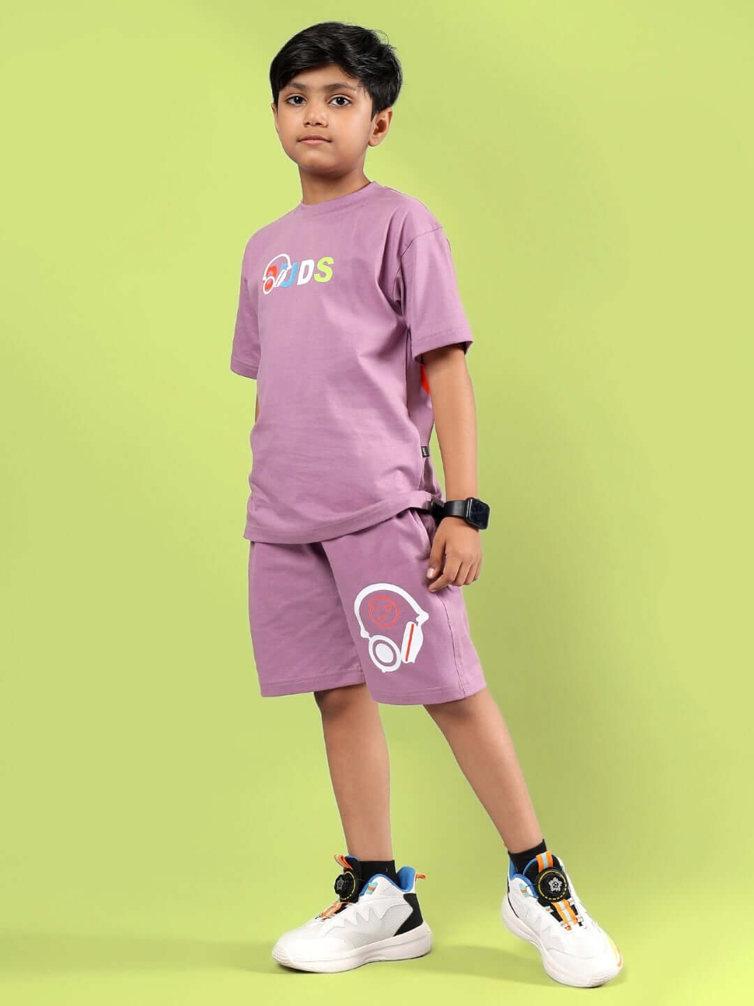 Boy wearing STOIC CO-ORD for boys & girls in Pulm Purple from DUDS, featuring comfortable and stylish design on a green background.