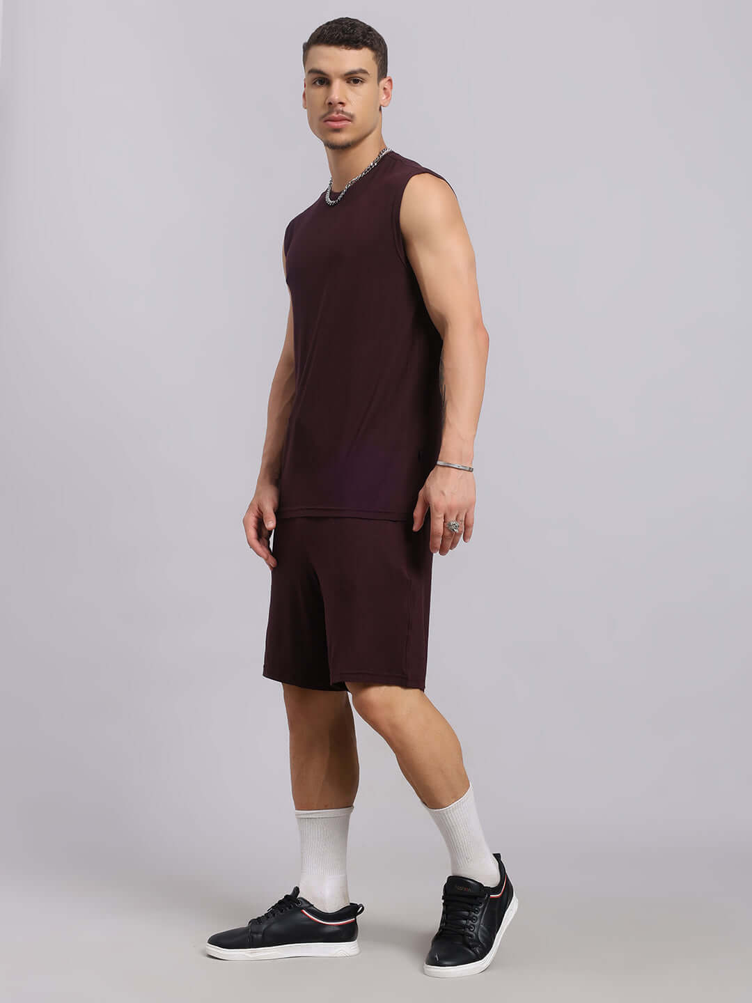 Man wearing STRENGTH FREAK CO-ORD SET in wine color, premium modal fabric, casual athletic wear, perfect for workouts or leisure, side view.