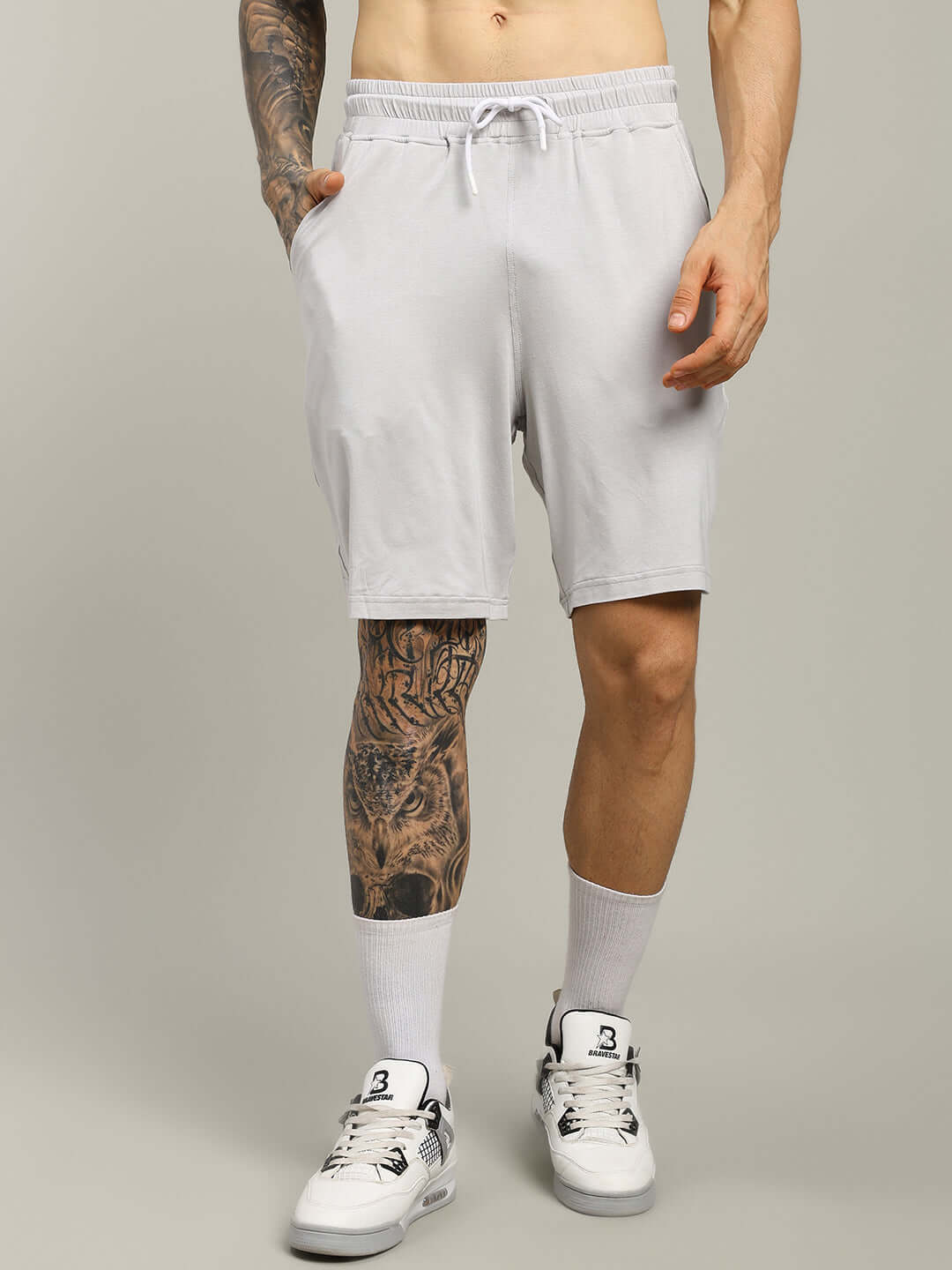Light grey STRENGTH FREAK shorts, shown on a model, showcasing custom fit options for a personalized size experience.