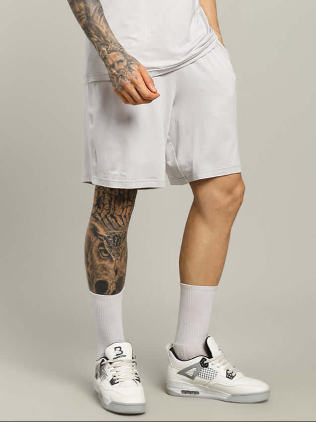 Model wearing STRENGTH FREAK Shorts in light grey, featuring a custom fit option for personalized sizing and optimal comfort.