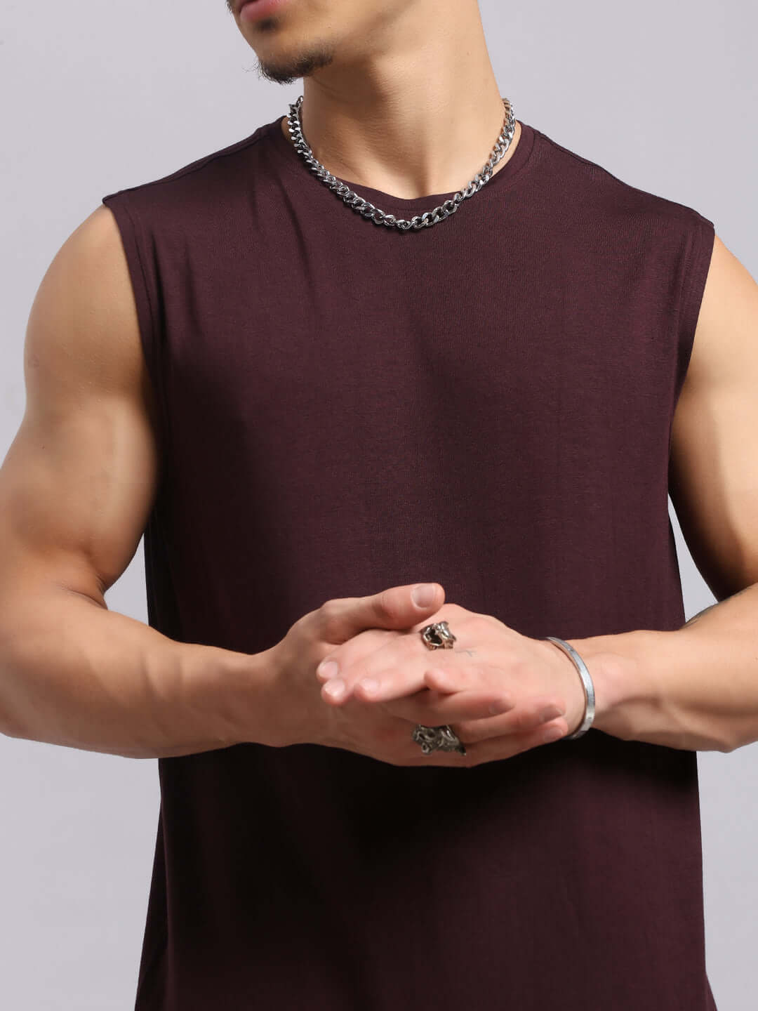 Model wearing Strength Freak Fitness T-Shirt in wine, showcasing sleeveless design and relaxed fit perfect for summer.