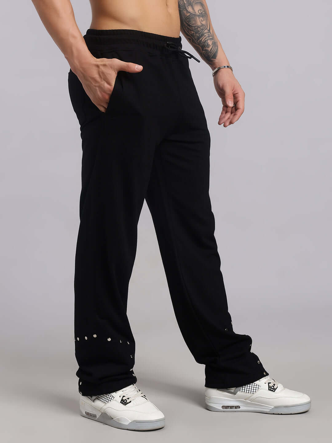 Model wearing Stunner Relaxed Fit Jogger in black by DUDS, showcasing made-to-order craftsmanship with custom fit option.